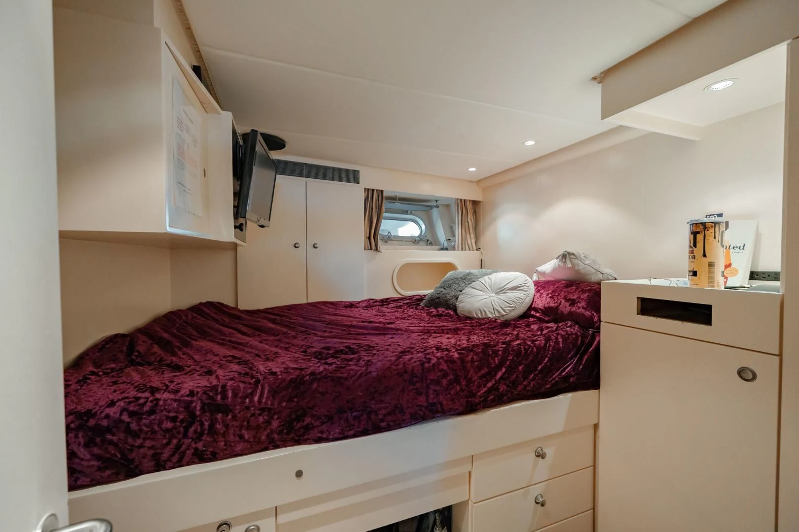 a bedroom with a bed and a desk aboard DREAM RIDER Yacht for Sale