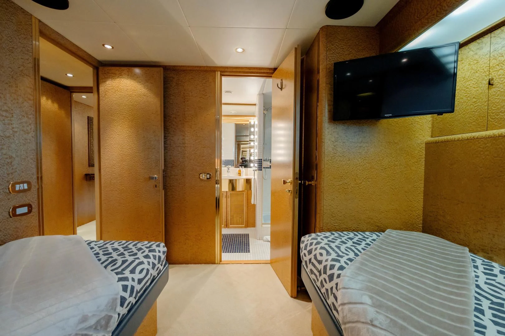 a room with beds and a closet aboard DREAM RIDER Yacht for Sale