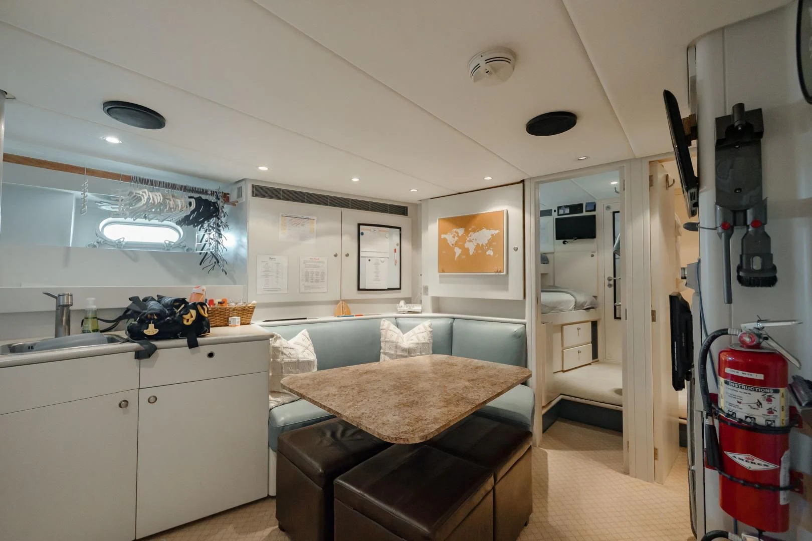 a kitchen with a table and chairs aboard DREAM RIDER Yacht for Sale