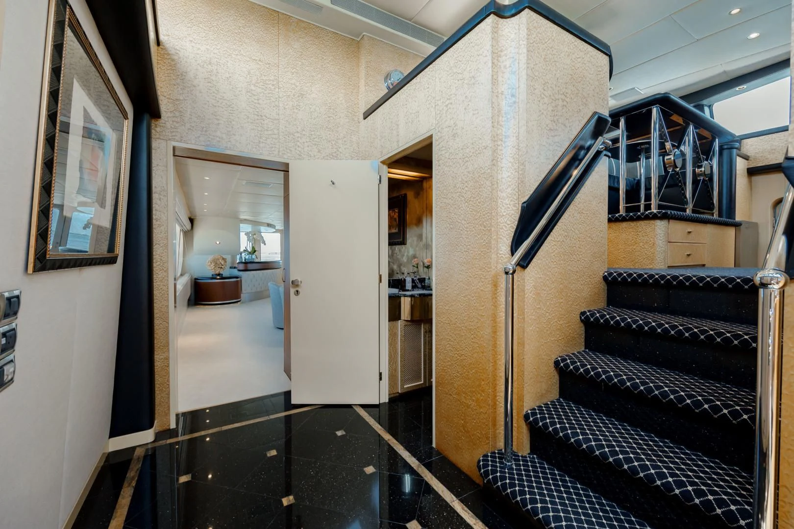 a hallway with a staircase and a glass door aboard DREAM RIDER Yacht for Sale