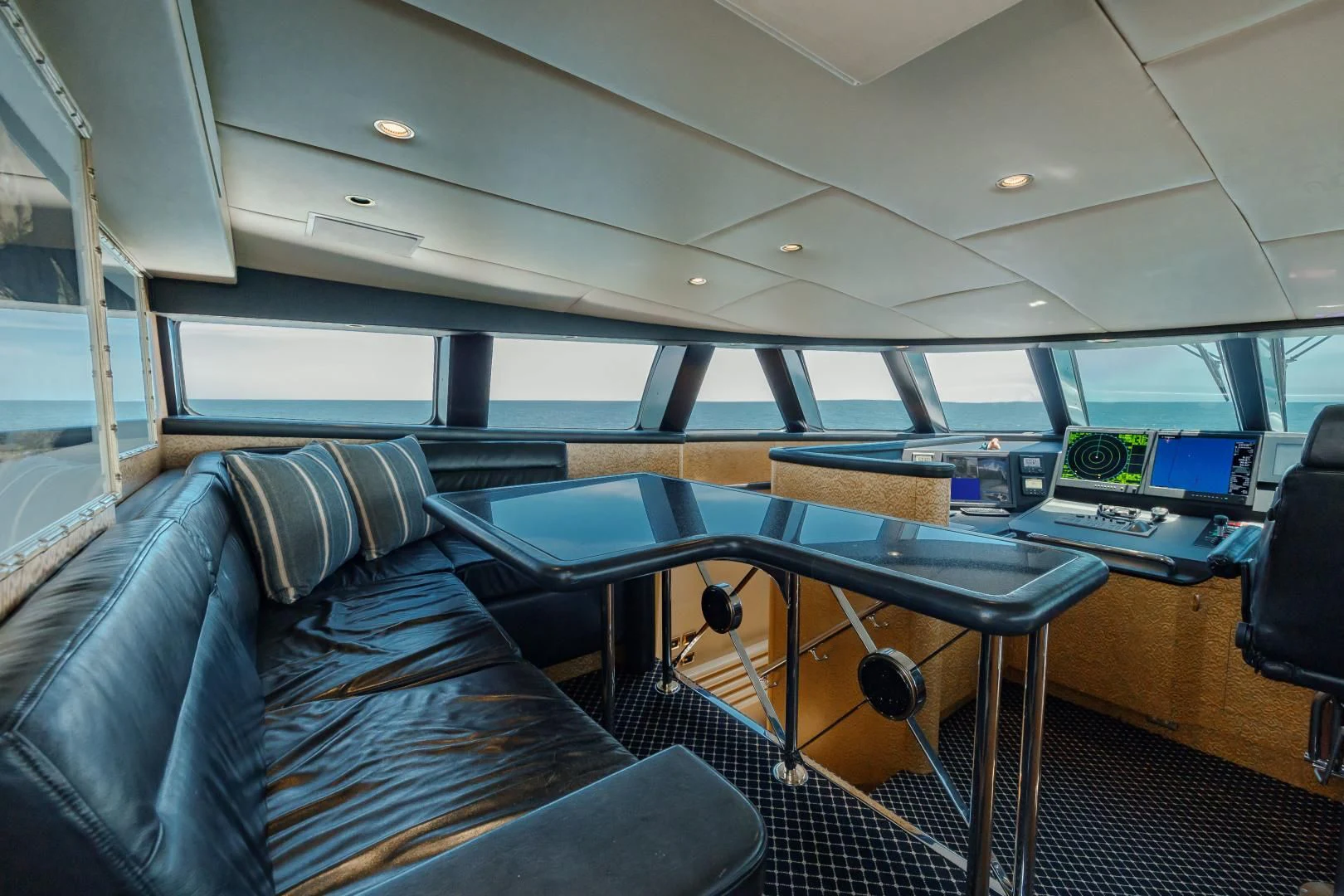 a room with a couch and a table with chairs aboard DREAM RIDER Yacht for Sale