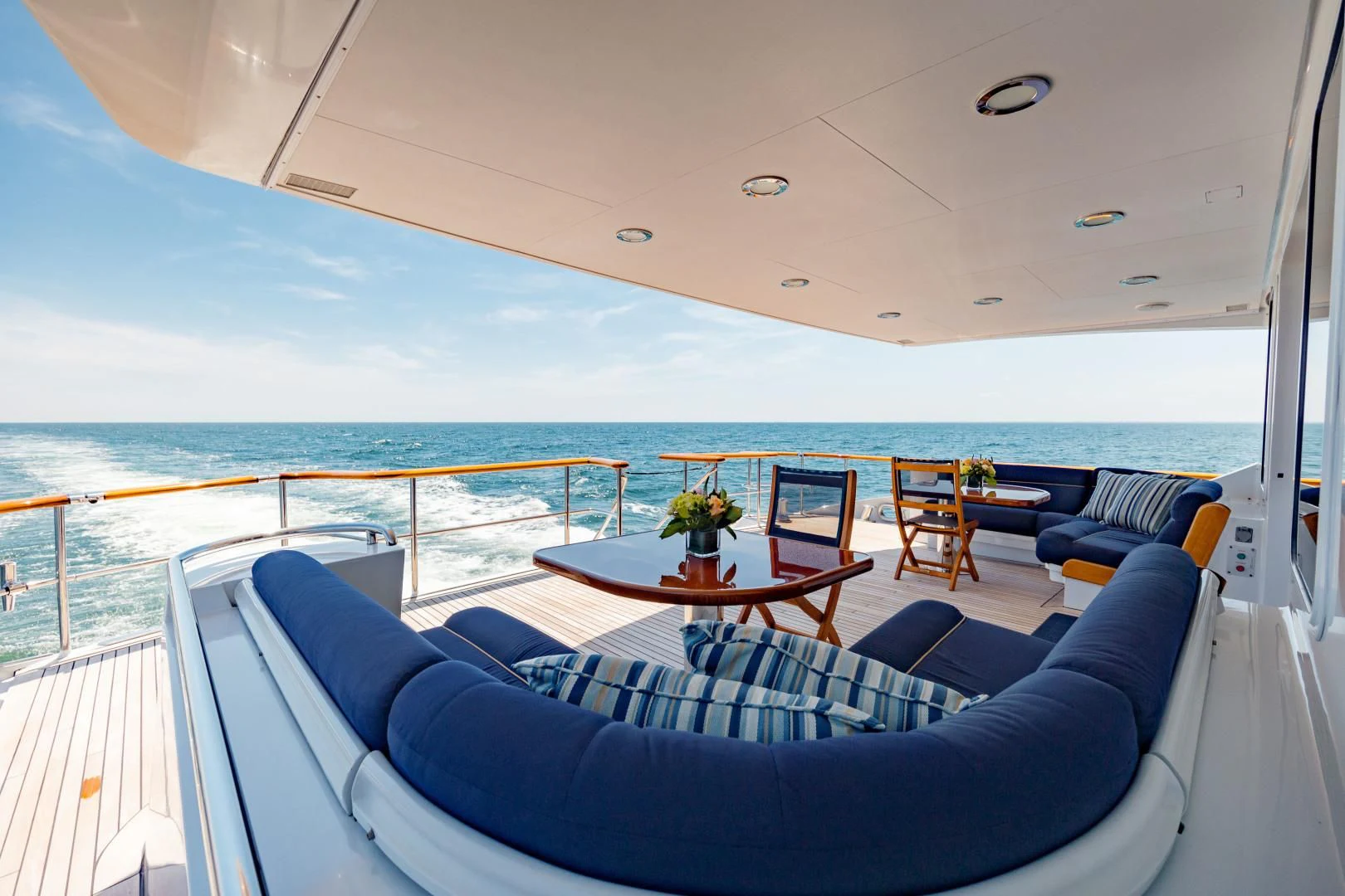 a boat with a table and chairs on the deck aboard DREAM RIDER Yacht for Sale