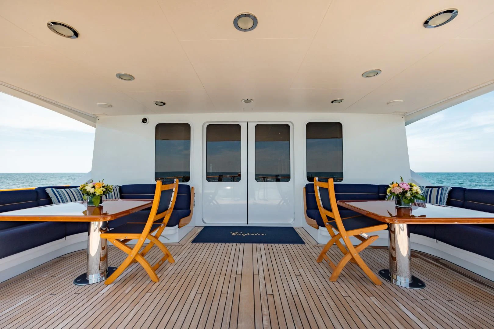 a room with a table and chairs aboard DREAM RIDER Yacht for Sale