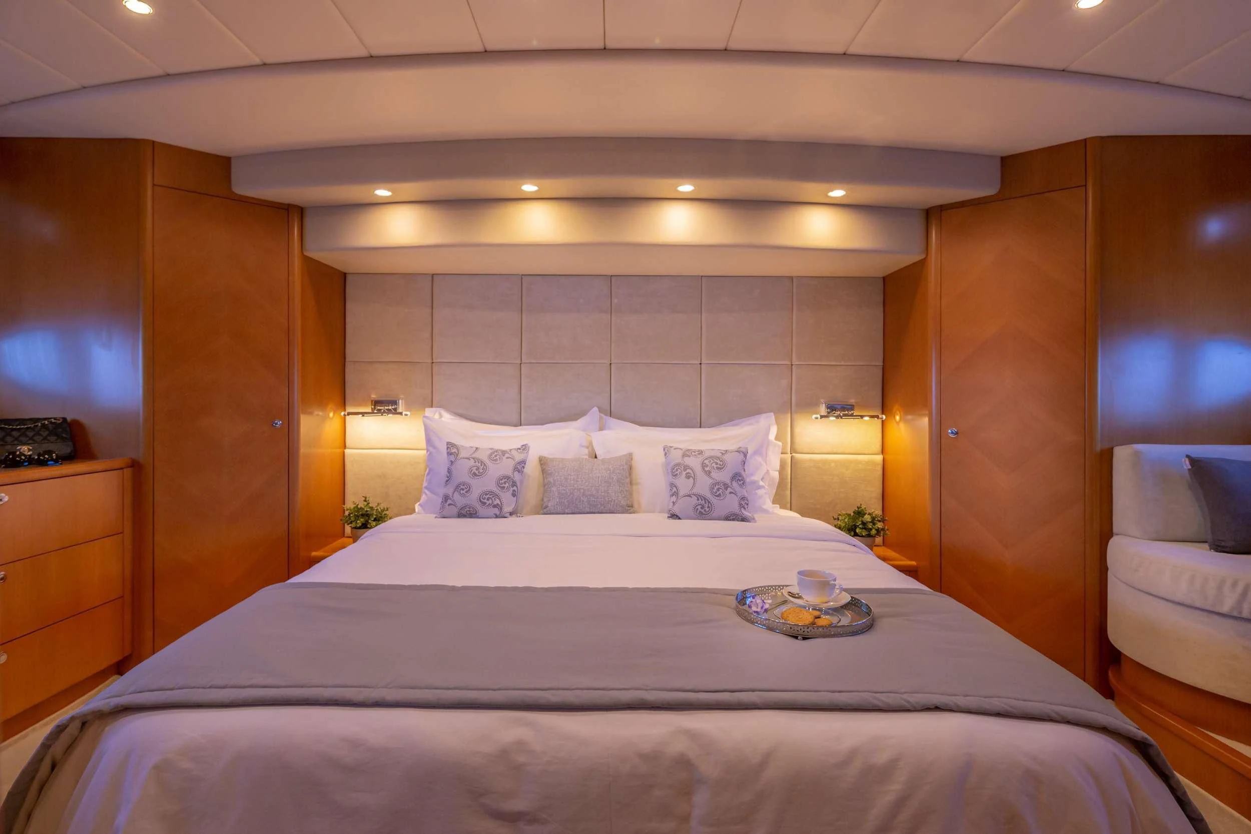 a bed with a white sheet and pillows aboard LEGEND Yacht for Sale