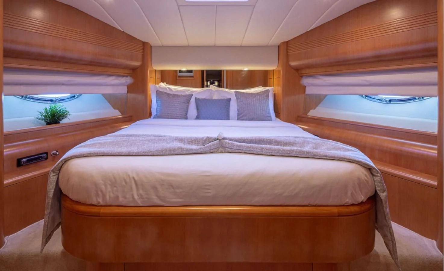 a bed with a wooden headboard aboard LEGEND Yacht for Sale