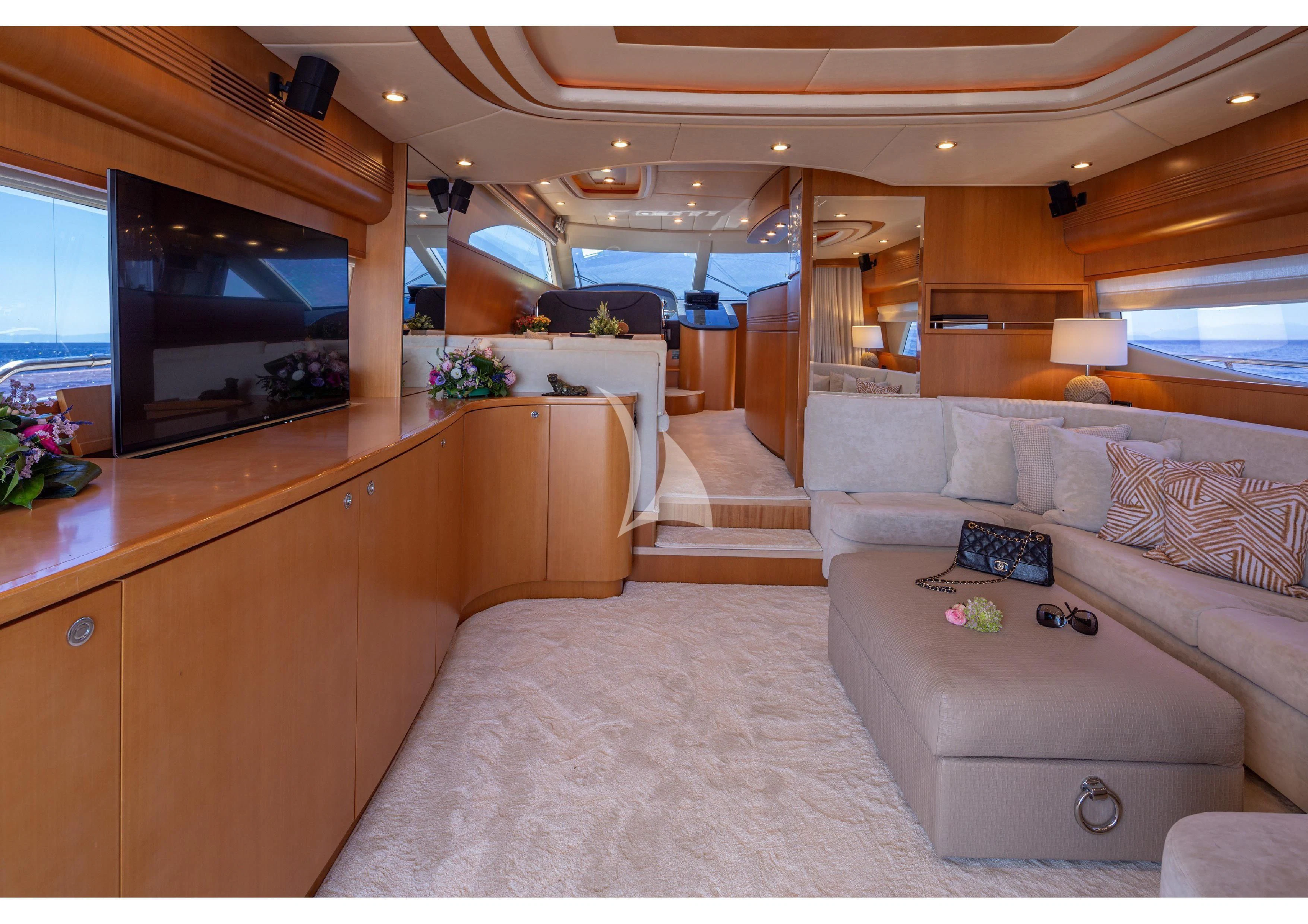 a living room with a couch and a tv aboard LEGEND Yacht for Sale