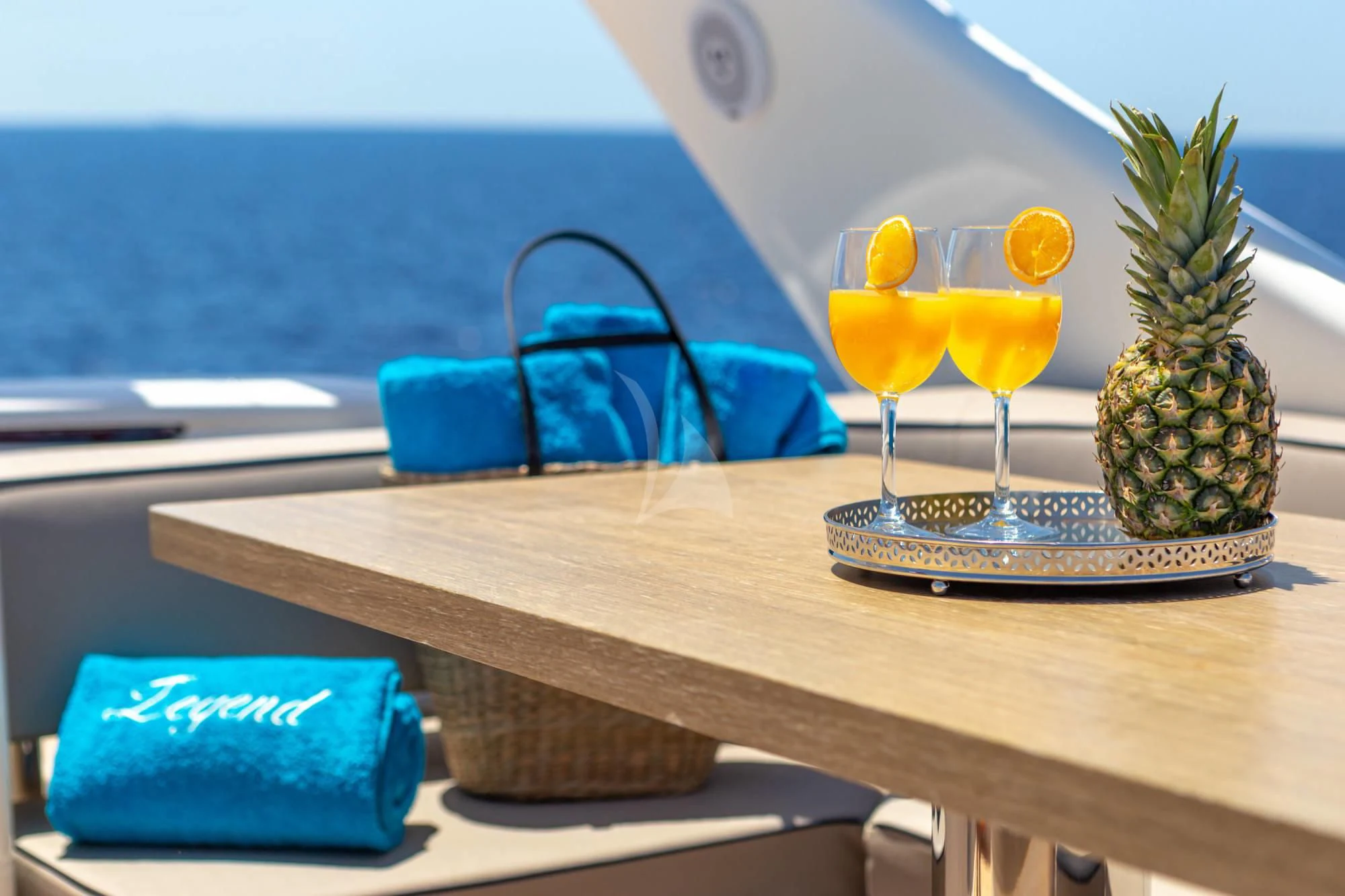 a table with drinks and fruits on it aboard LEGEND Yacht for Sale
