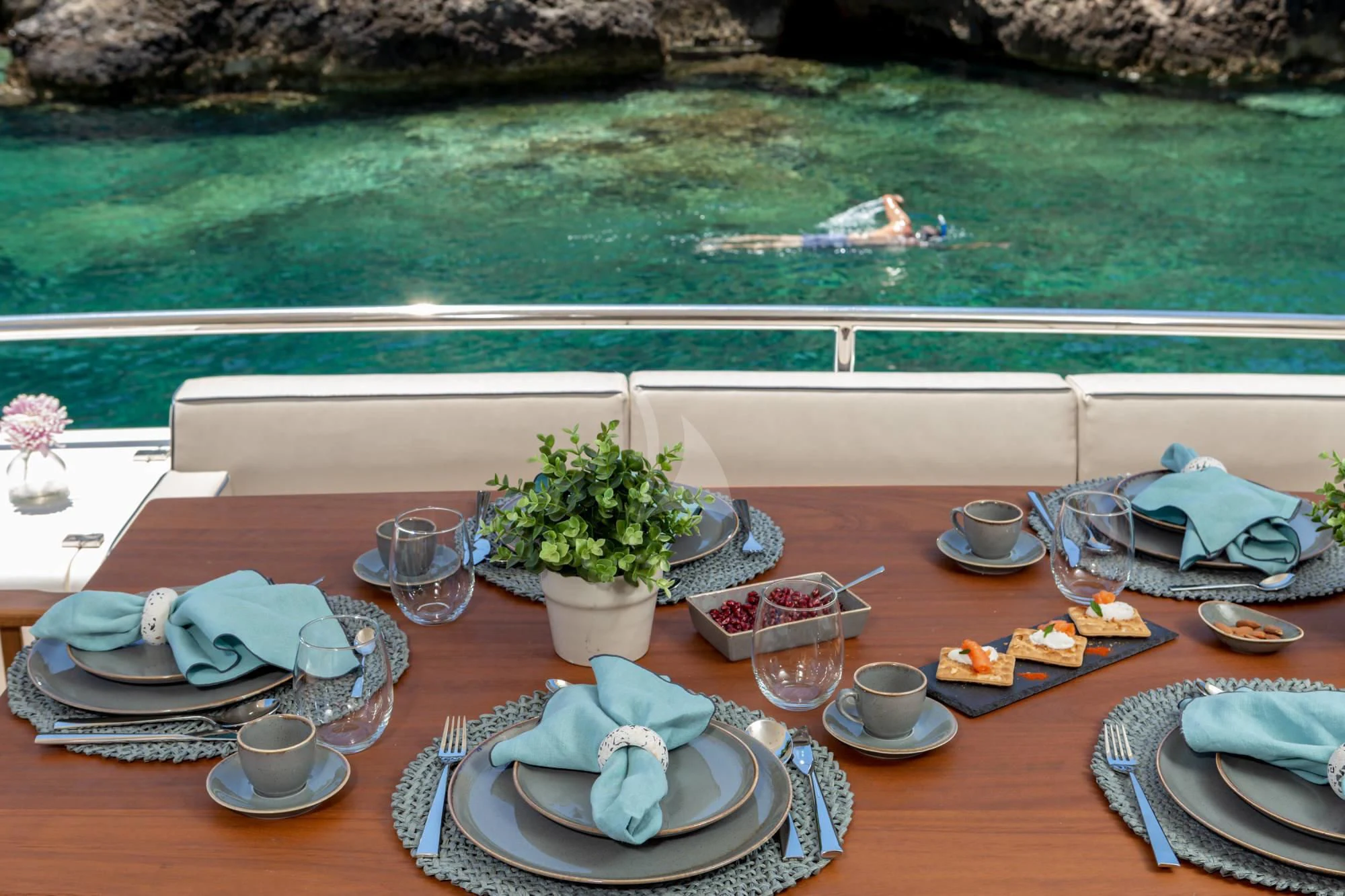 a table with plates and cups on it aboard LEGEND Yacht for Sale