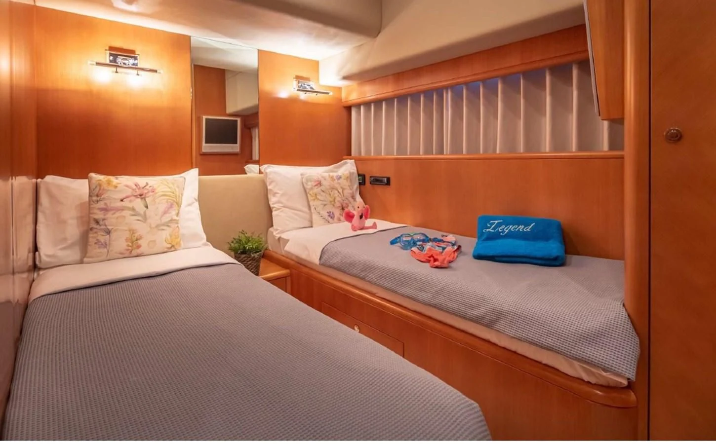a couple of beds in a room aboard LEGEND Yacht for Sale