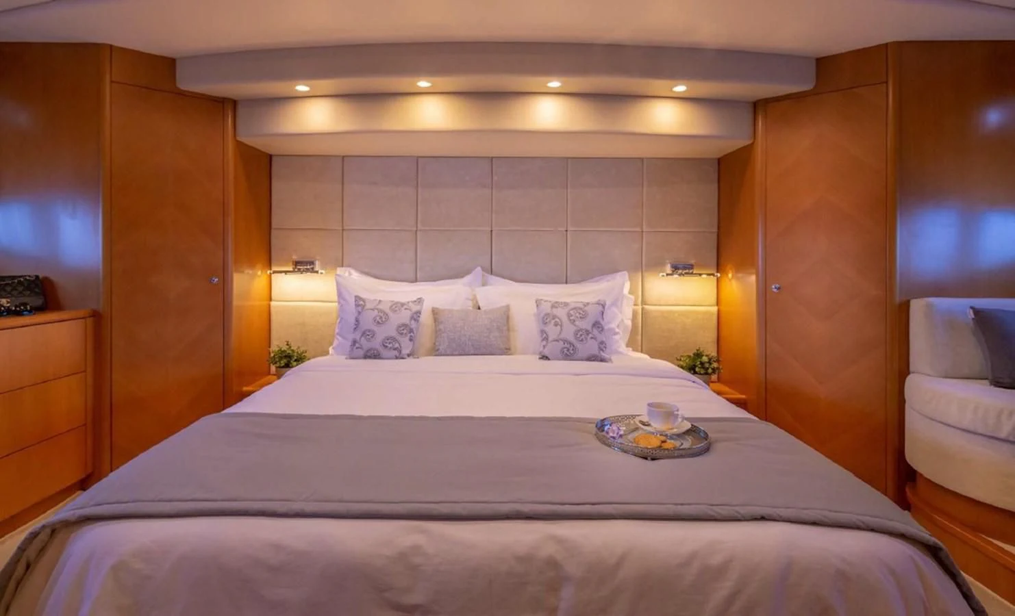 a bed with a white sheet and pillows on it aboard LEGEND Yacht for Sale