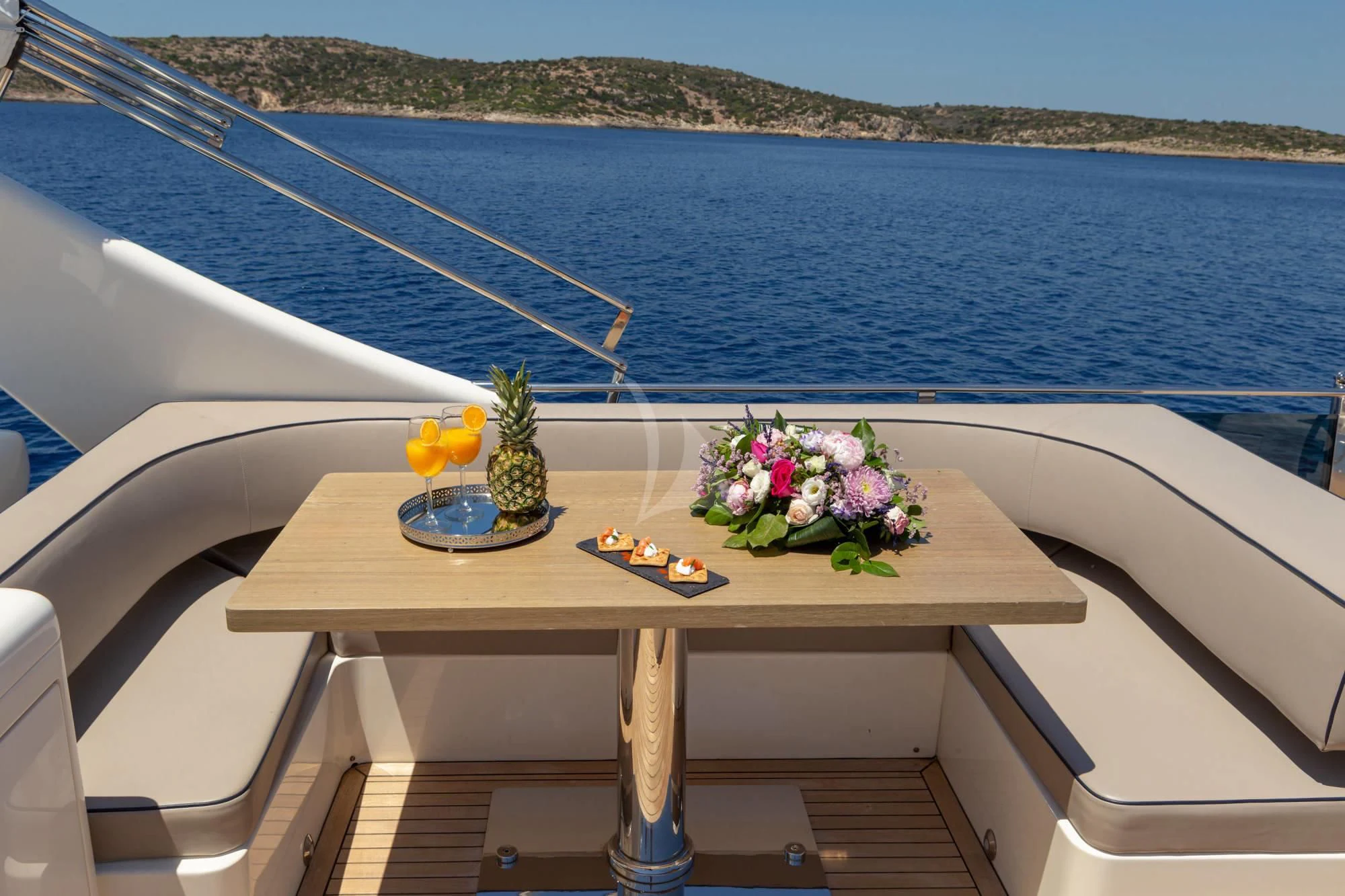 a table with flowers on it by the water aboard LEGEND Yacht for Sale