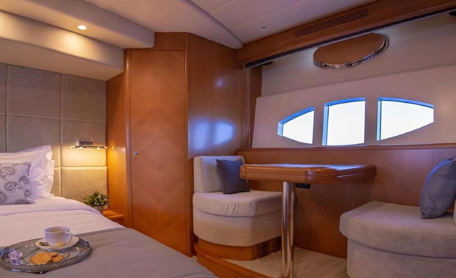 a room with a bed and a table aboard LEGEND Yacht for Sale
