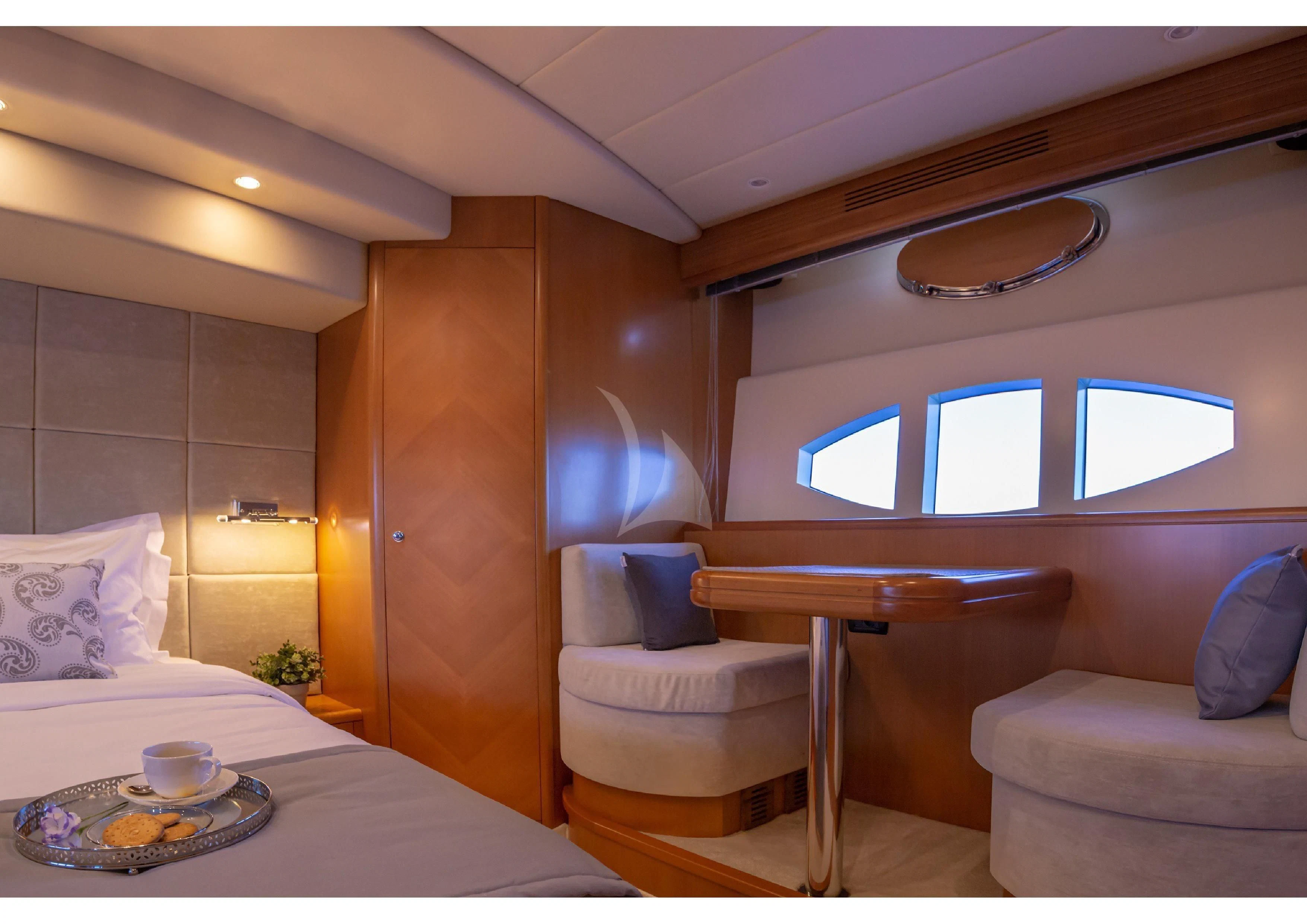 a room with a bed and a table aboard LEGEND Yacht for Sale