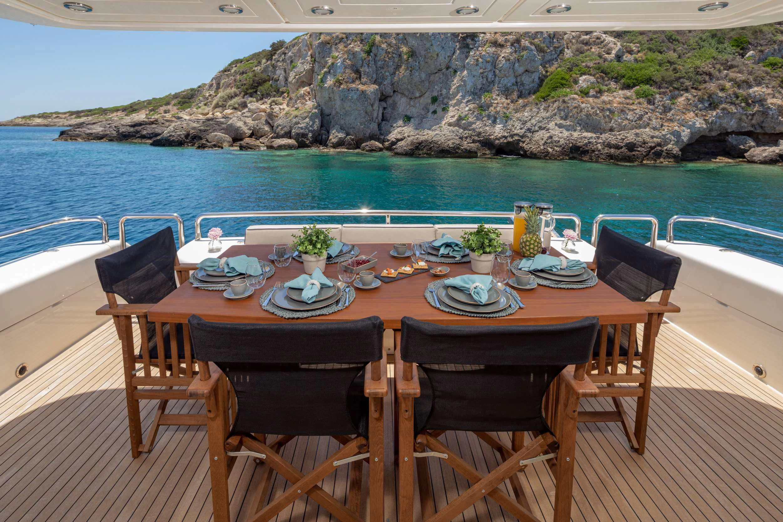a table set for a meal on a beach aboard LEGEND Yacht for Sale