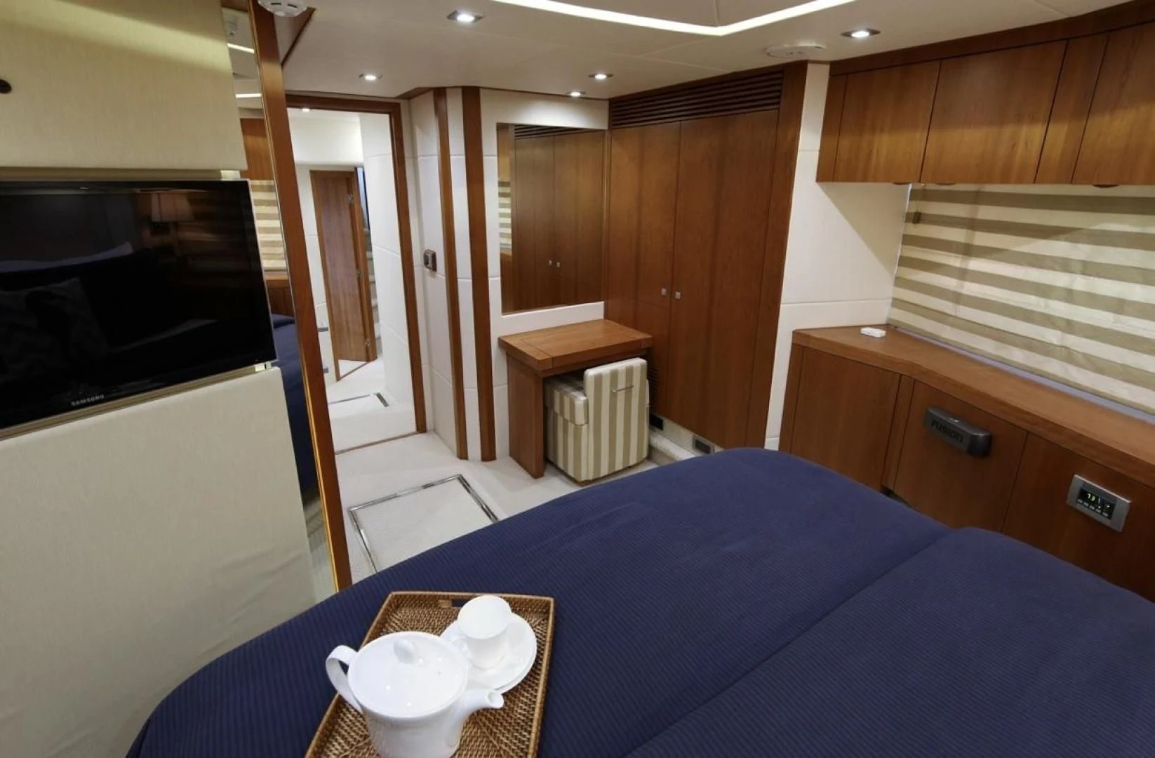a bed and a table in a room aboard SEA C Yacht for Sale
