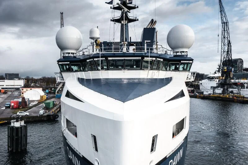 a large white ship in a harbor aboard DAWN Yacht for Sale