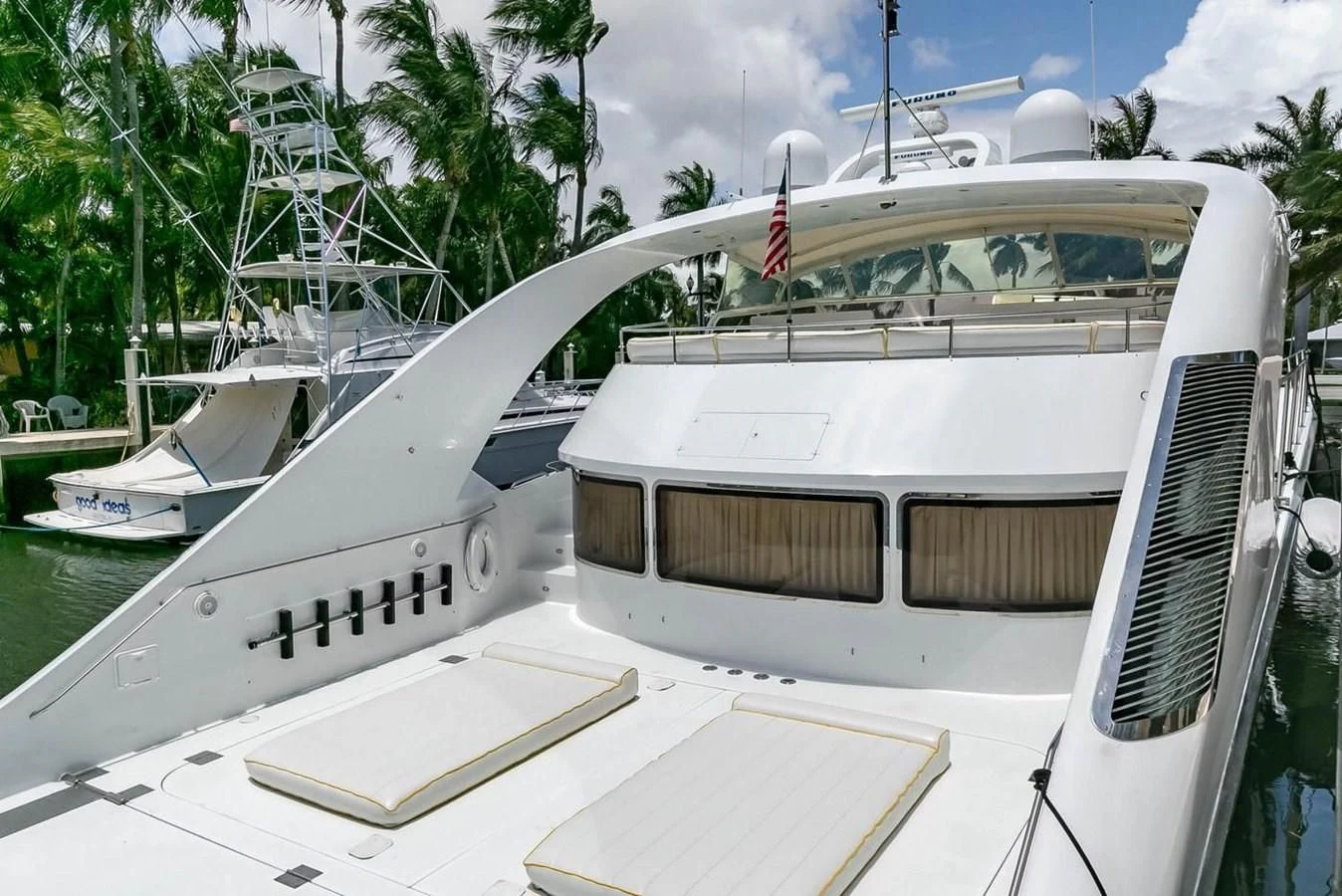a boat with a flag on the front aboard PURELY PLEASURE Yacht for Sale