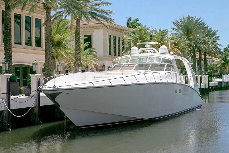 a white boat in a harbor aboard PURELY PLEASURE Yacht for Sale