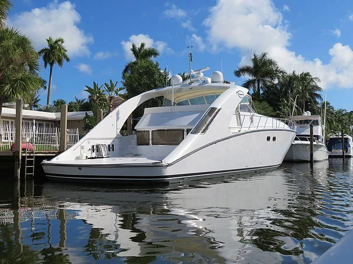 a boat docked at a pier aboard PURELY PLEASURE Yacht for Sale