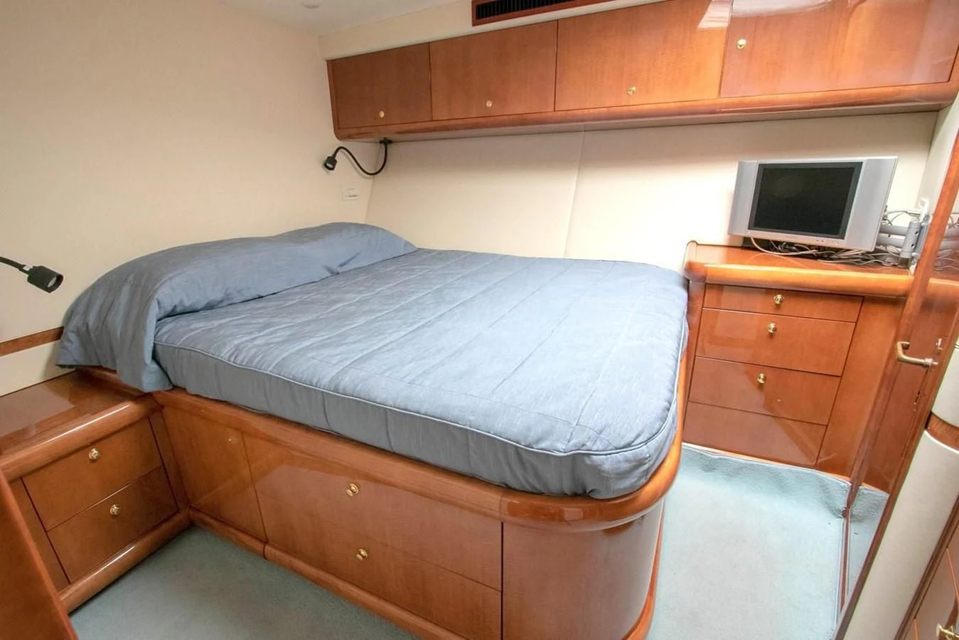 a bed with a desk and a computer aboard PURELY PLEASURE Yacht for Sale