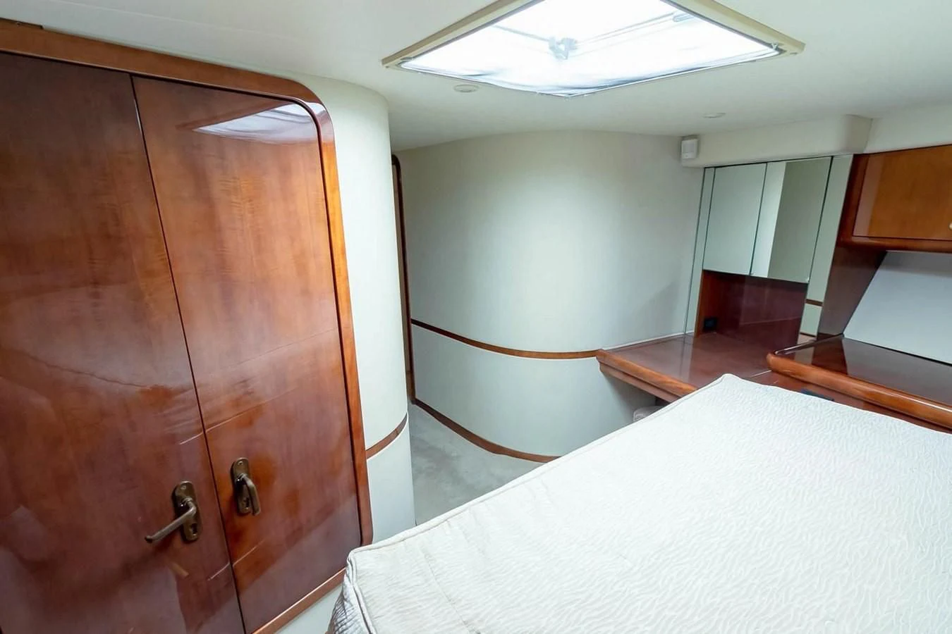 a room with a bed and a closet aboard PURELY PLEASURE Yacht for Sale