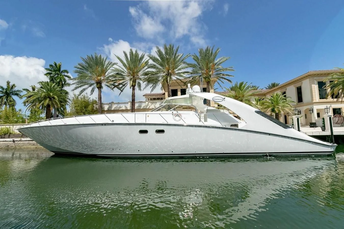 a white boat on the water aboard PURELY PLEASURE Yacht for Sale