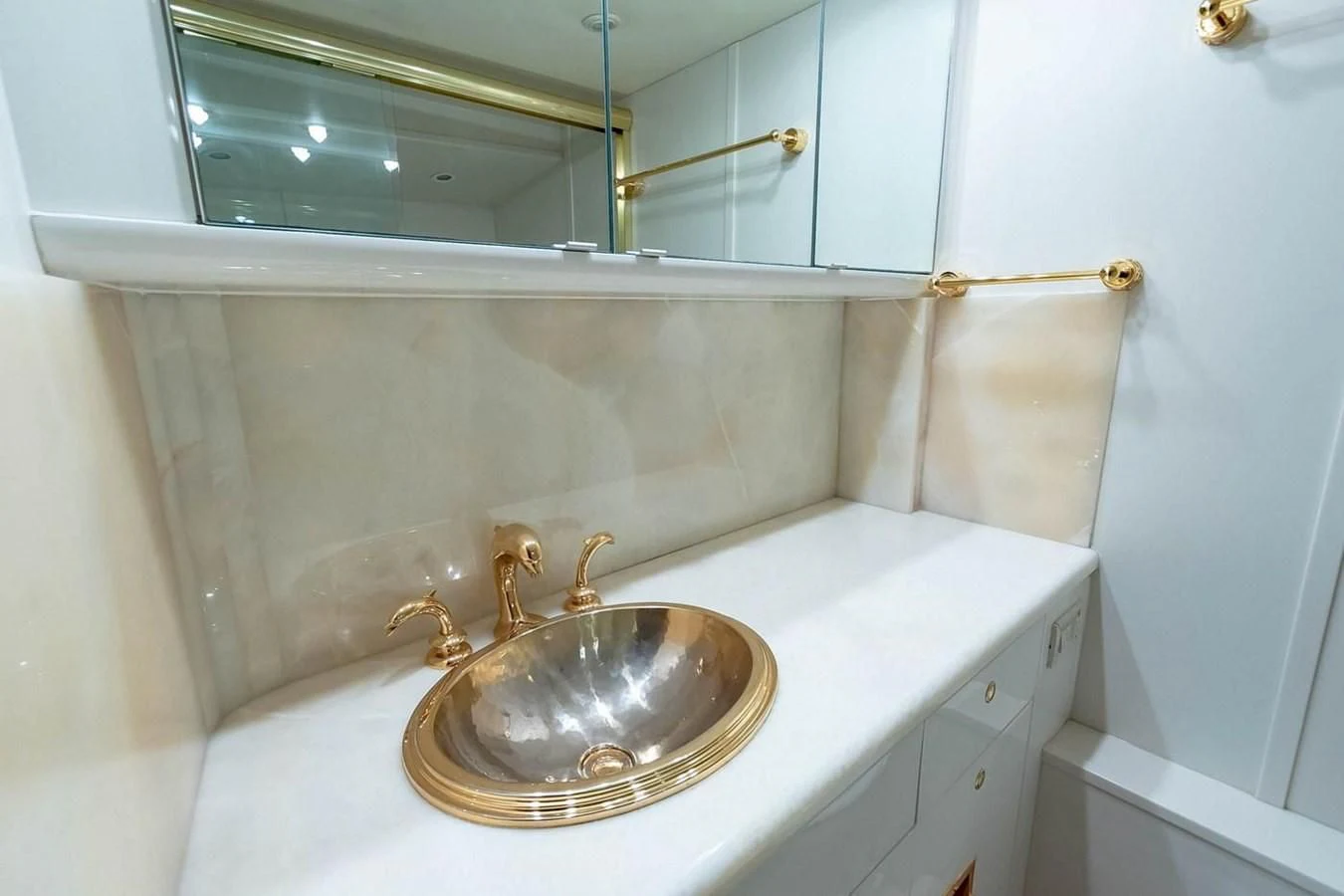 a bathroom with a sink and a mirror aboard PURELY PLEASURE Yacht for Sale