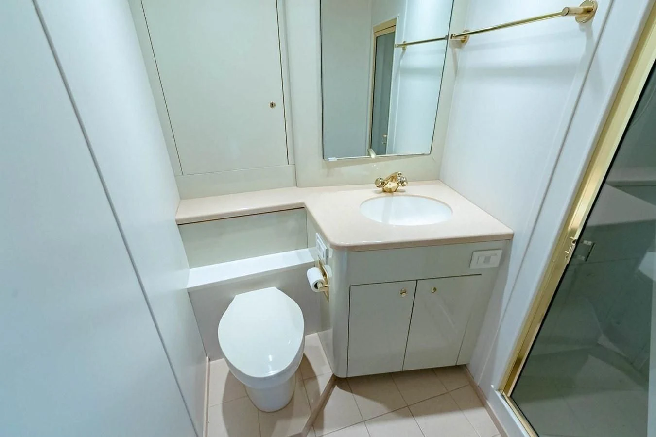 a bathroom with a toilet and sink aboard PURELY PLEASURE Yacht for Sale