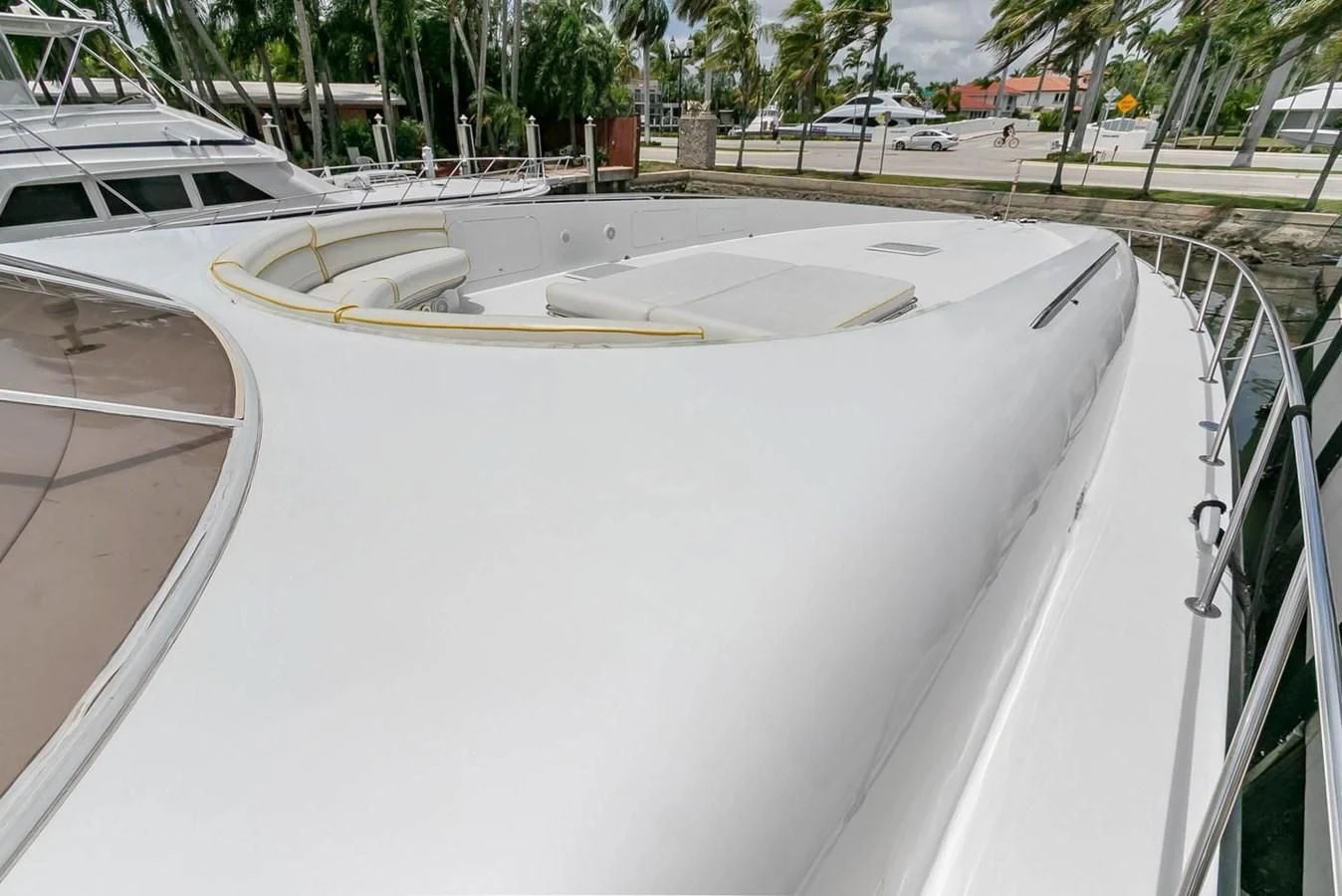 a white boat on a dock aboard PURELY PLEASURE Yacht for Sale