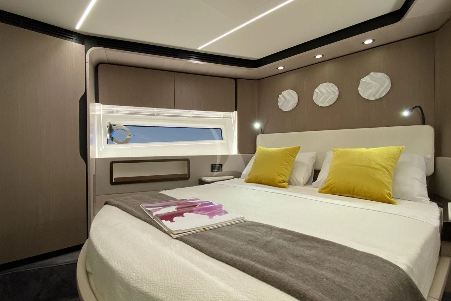 a room with a bed and a shelf with pillows aboard SOLSTICE Yacht for Sale