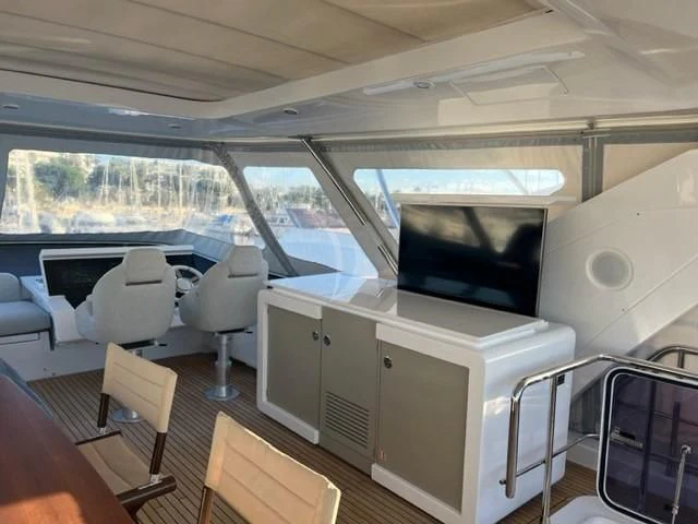 inside of a vehicle with a large window and a tv on the side aboard SOLSTICE Yacht for Sale