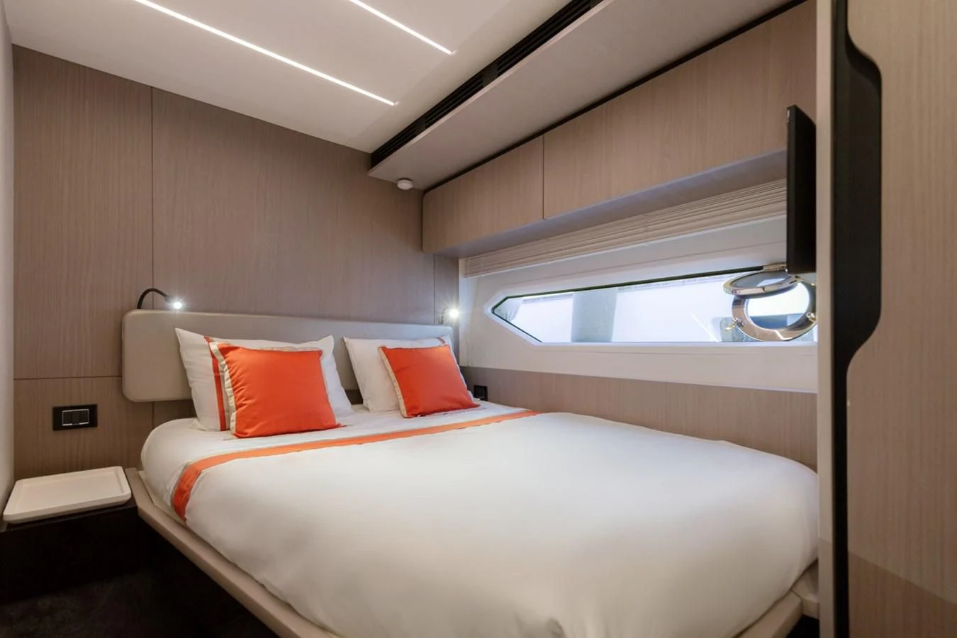 a room with a bed and a window aboard SOLSTICE Yacht for Sale