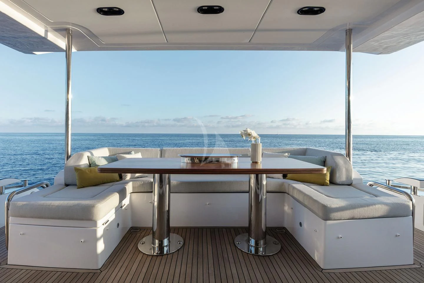 a table on a balcony overlooking the ocean aboard SOLSTICE Yacht for Sale
