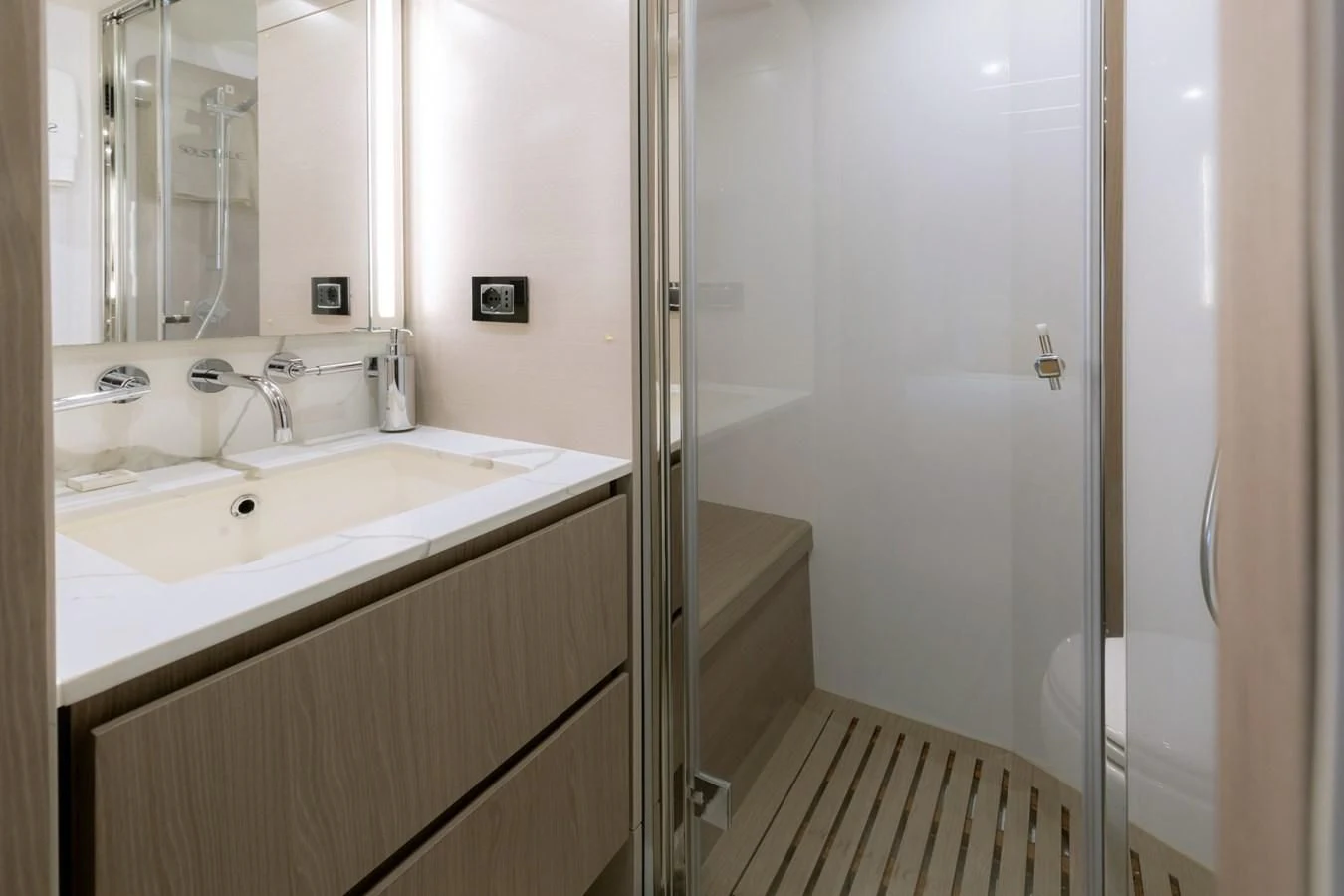 a bathroom with a shower unit and sink aboard SOLSTICE Yacht for Sale