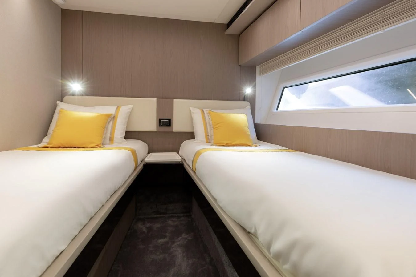 a room with beds and a window aboard SOLSTICE Yacht for Sale