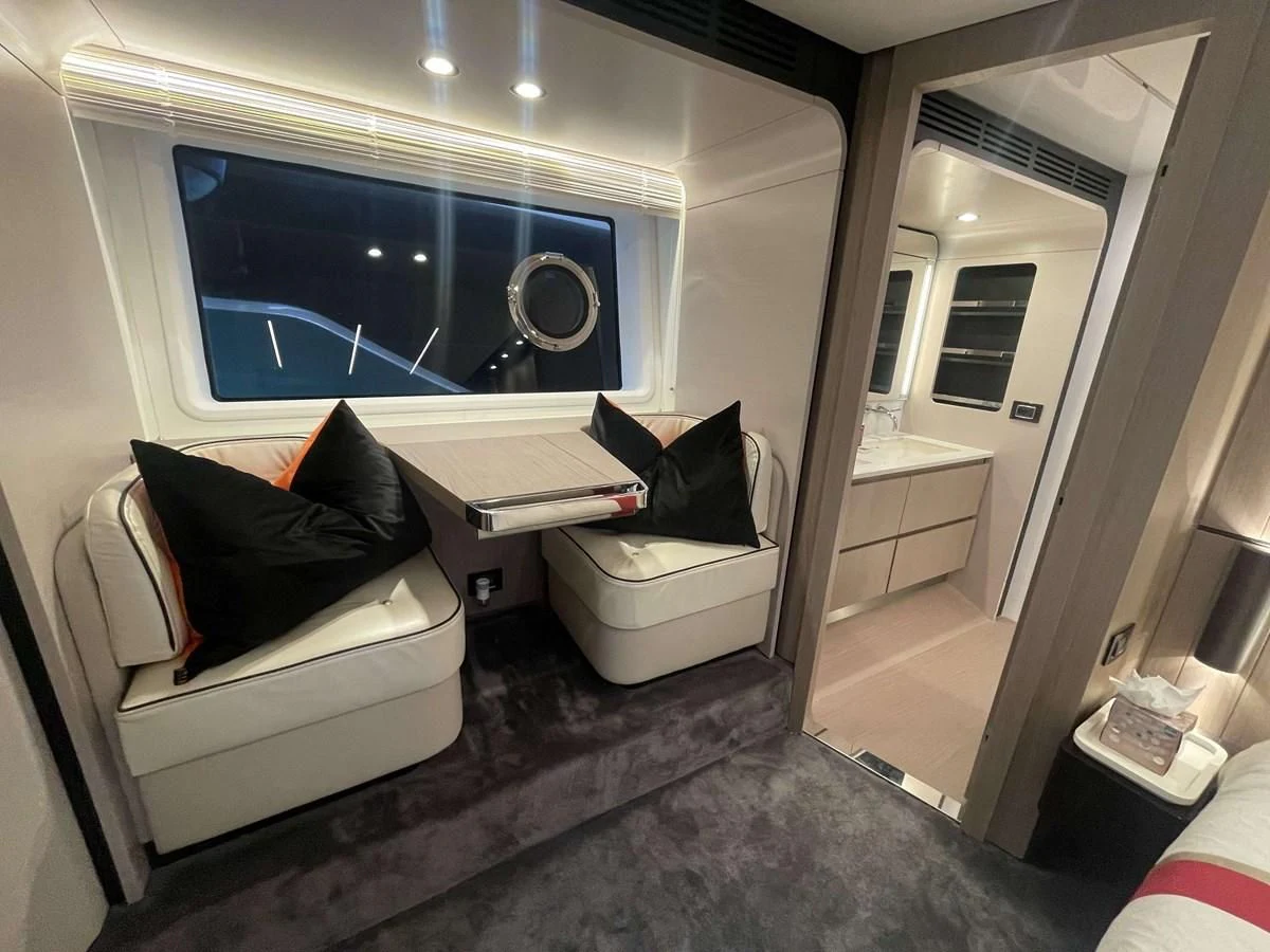 a room with a couch and a mirror aboard SOLSTICE Yacht for Sale