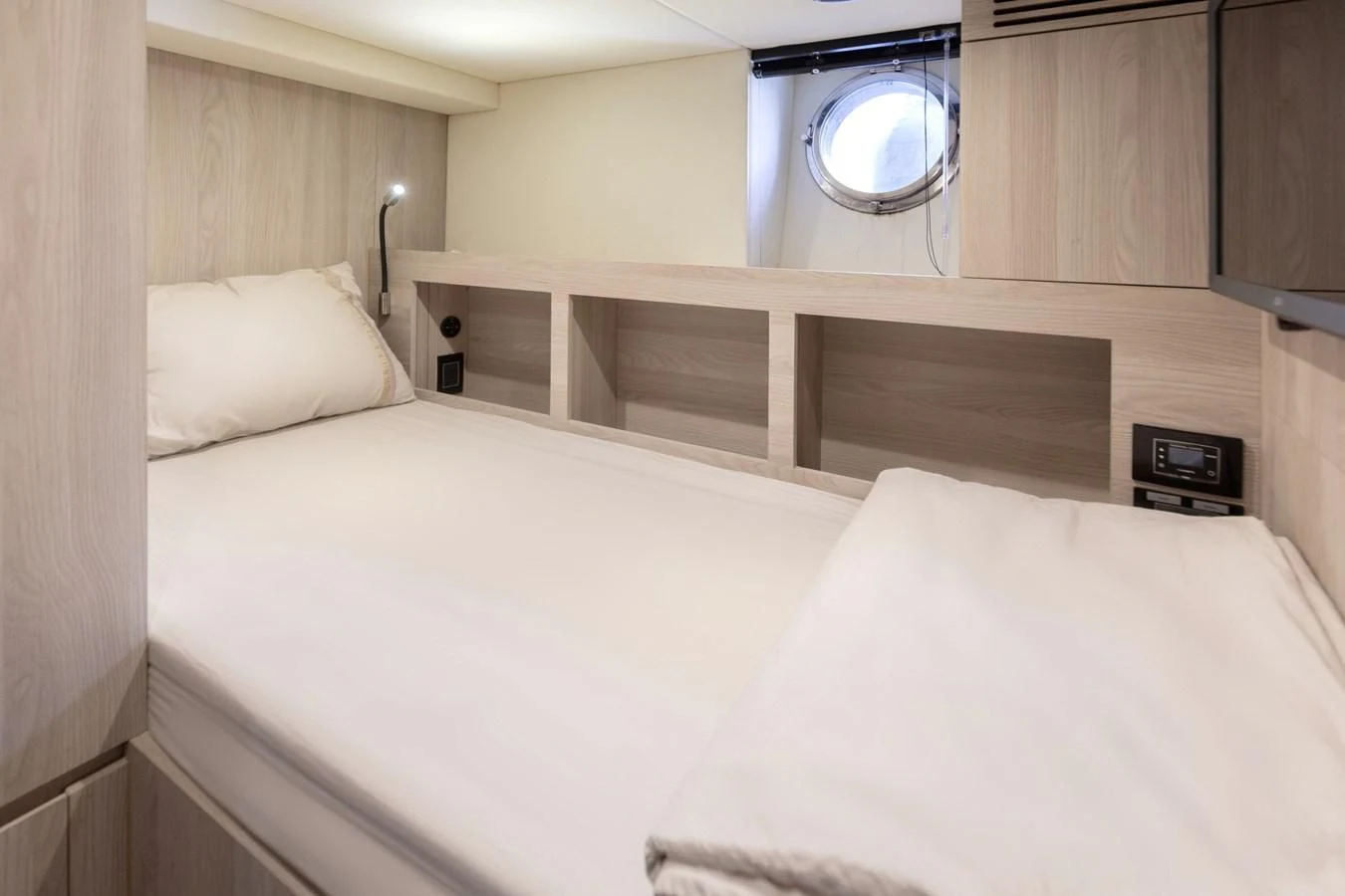 a bed with white sheets aboard SOLSTICE Yacht for Sale
