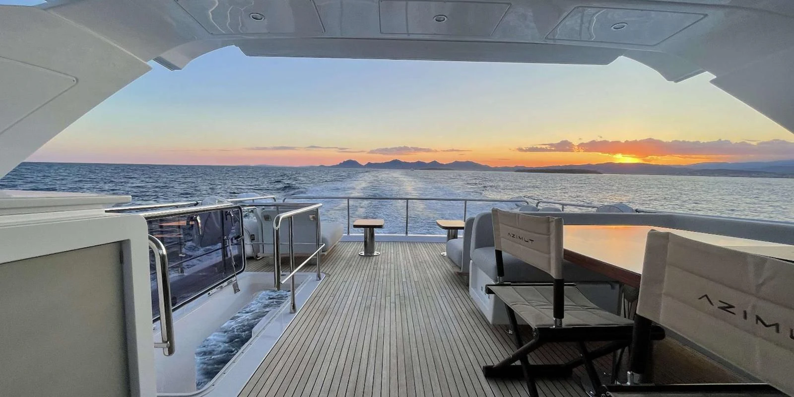 a deck overlooking a sunset aboard SOLSTICE Yacht for Sale