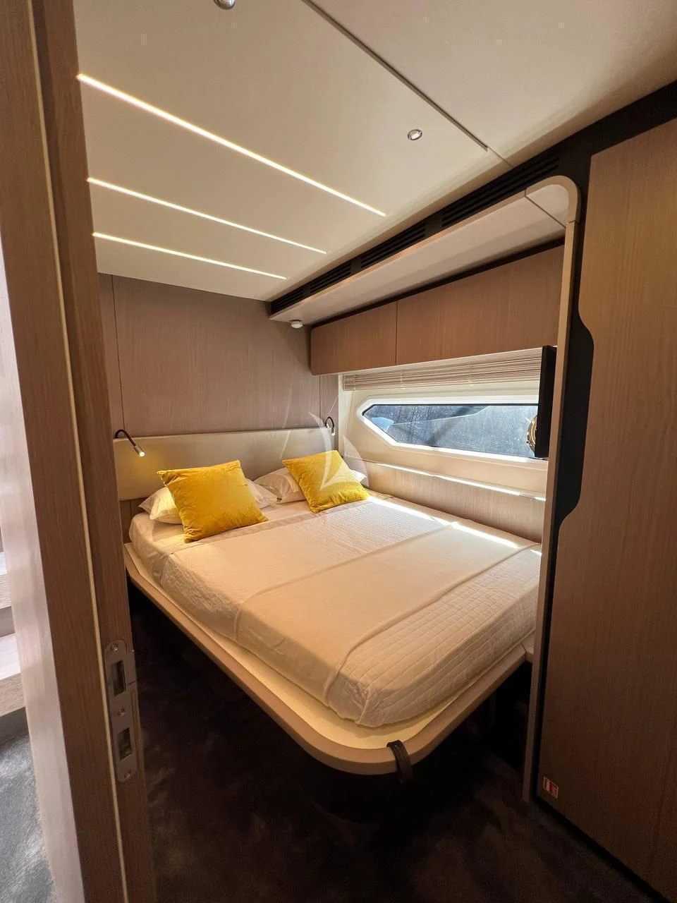 a room with a bed and a window aboard SOLSTICE Yacht for Sale