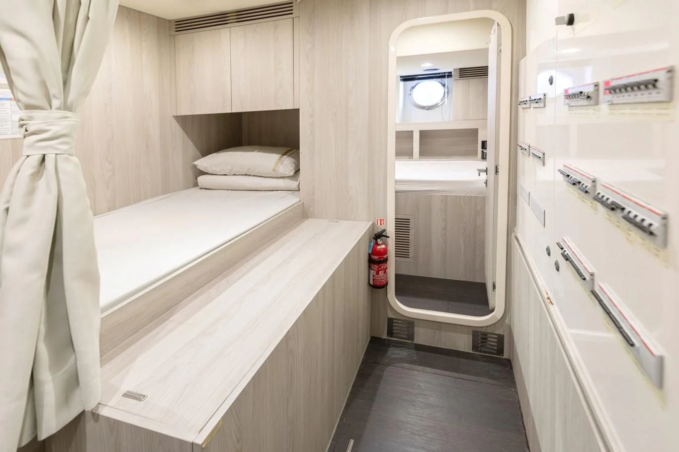 a small room with a bed and a mirror aboard SOLSTICE Yacht for Sale