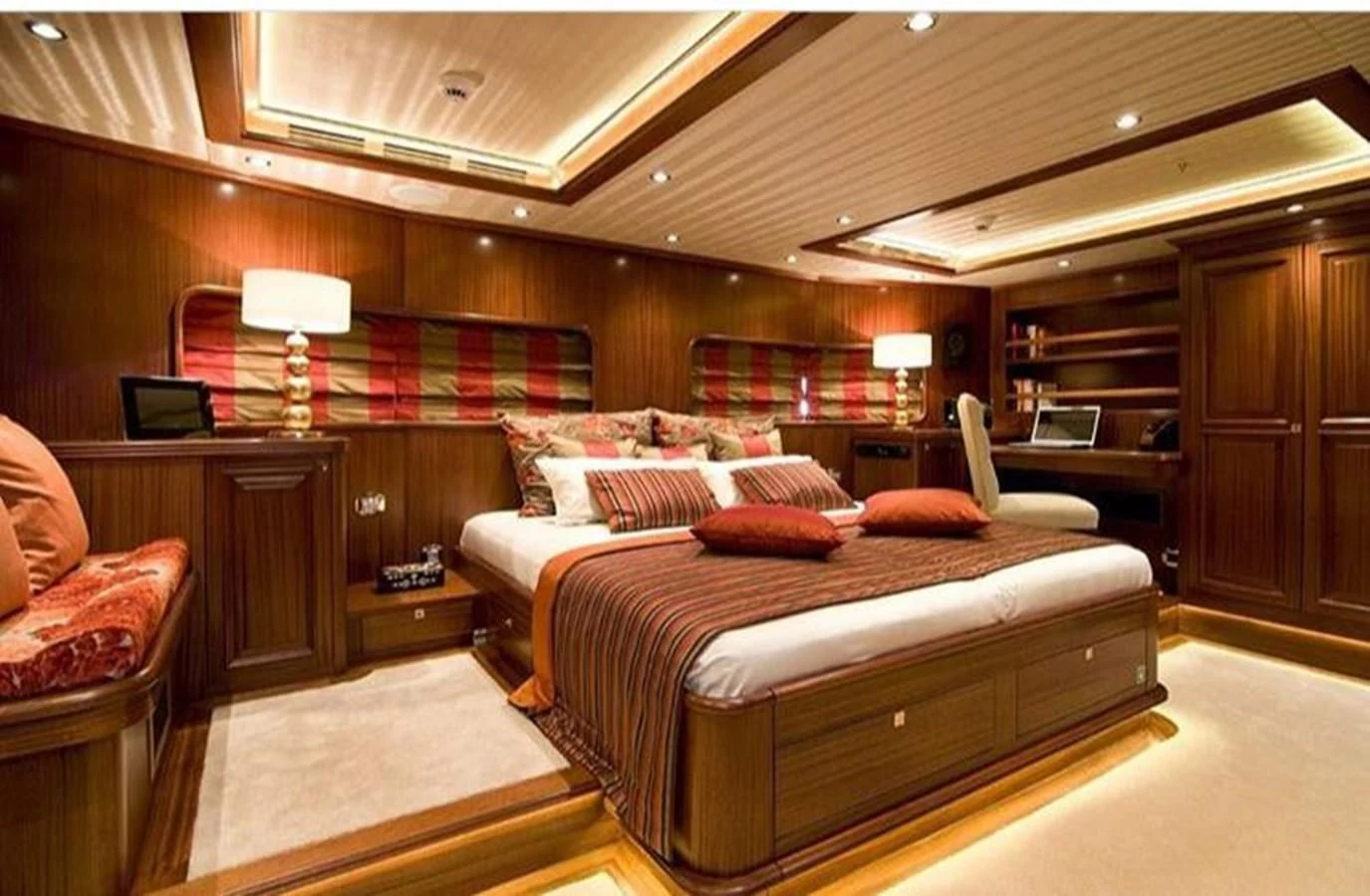 a bedroom with a bed and a desk aboard CLEAR EYES Yacht for Sale