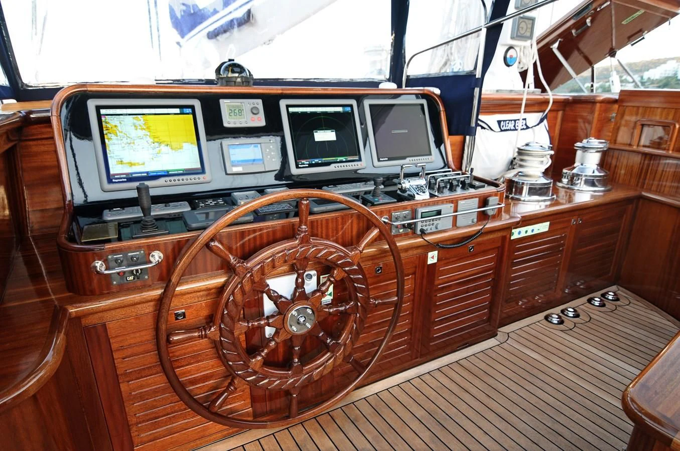 a wooden boat with a steering wheel aboard CLEAR EYES Yacht for Sale