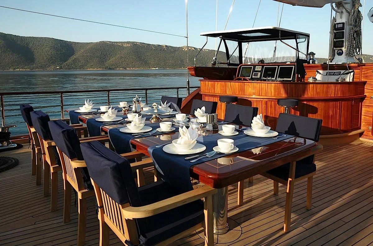 a table with plates and cups on it aboard CLEAR EYES Yacht for Sale