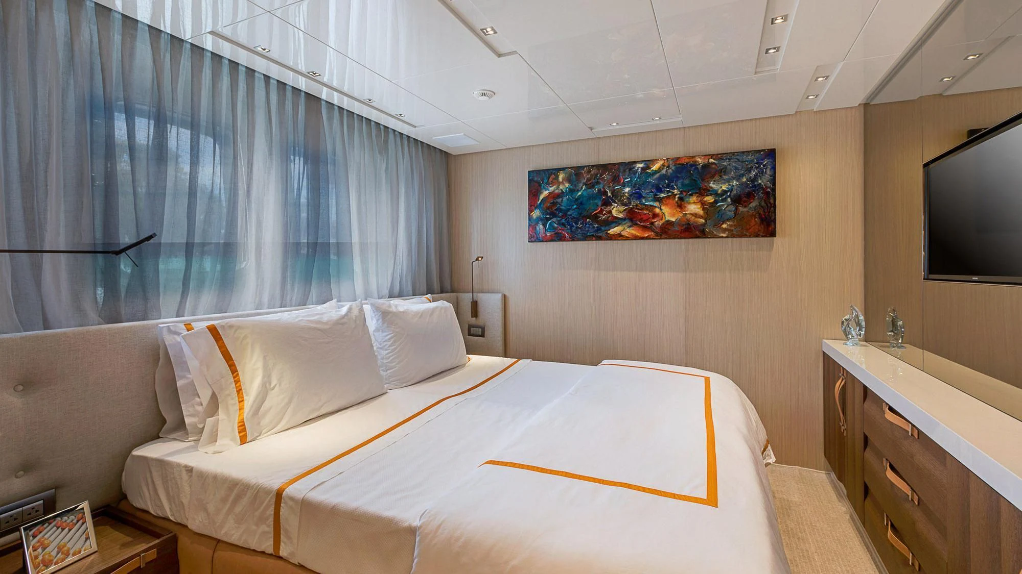 a room with a bed and a tv on the wall aboard CLEAR EYES Yacht for Sale