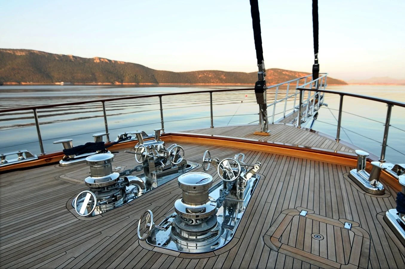 a deck with a large boat on it and a large body of water in the background aboard CLEAR EYES Yacht for Sale