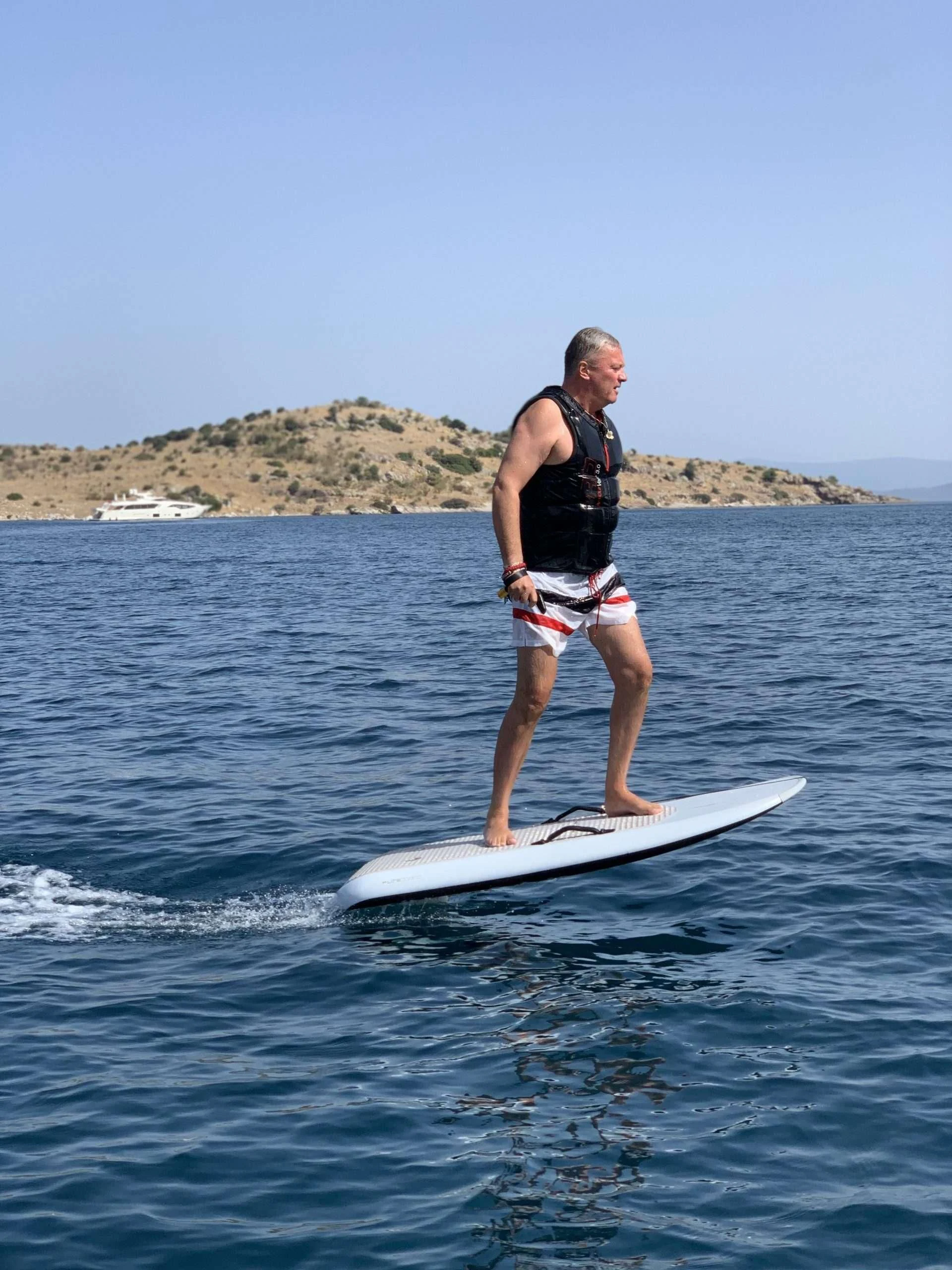a man surfing on the water aboard CLEAR EYES Yacht for Sale