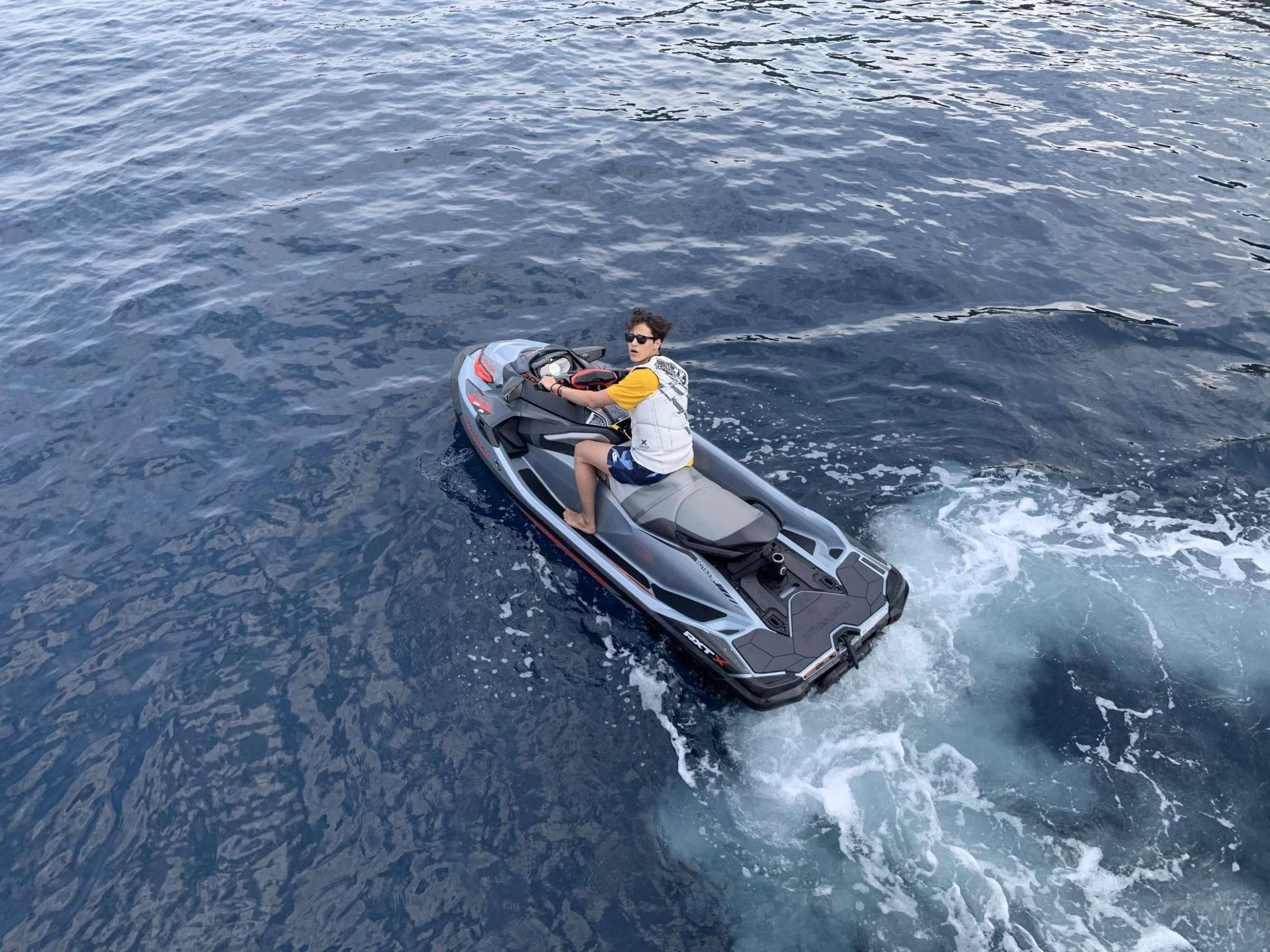 a man riding a jet ski aboard CLEAR EYES Yacht for Sale