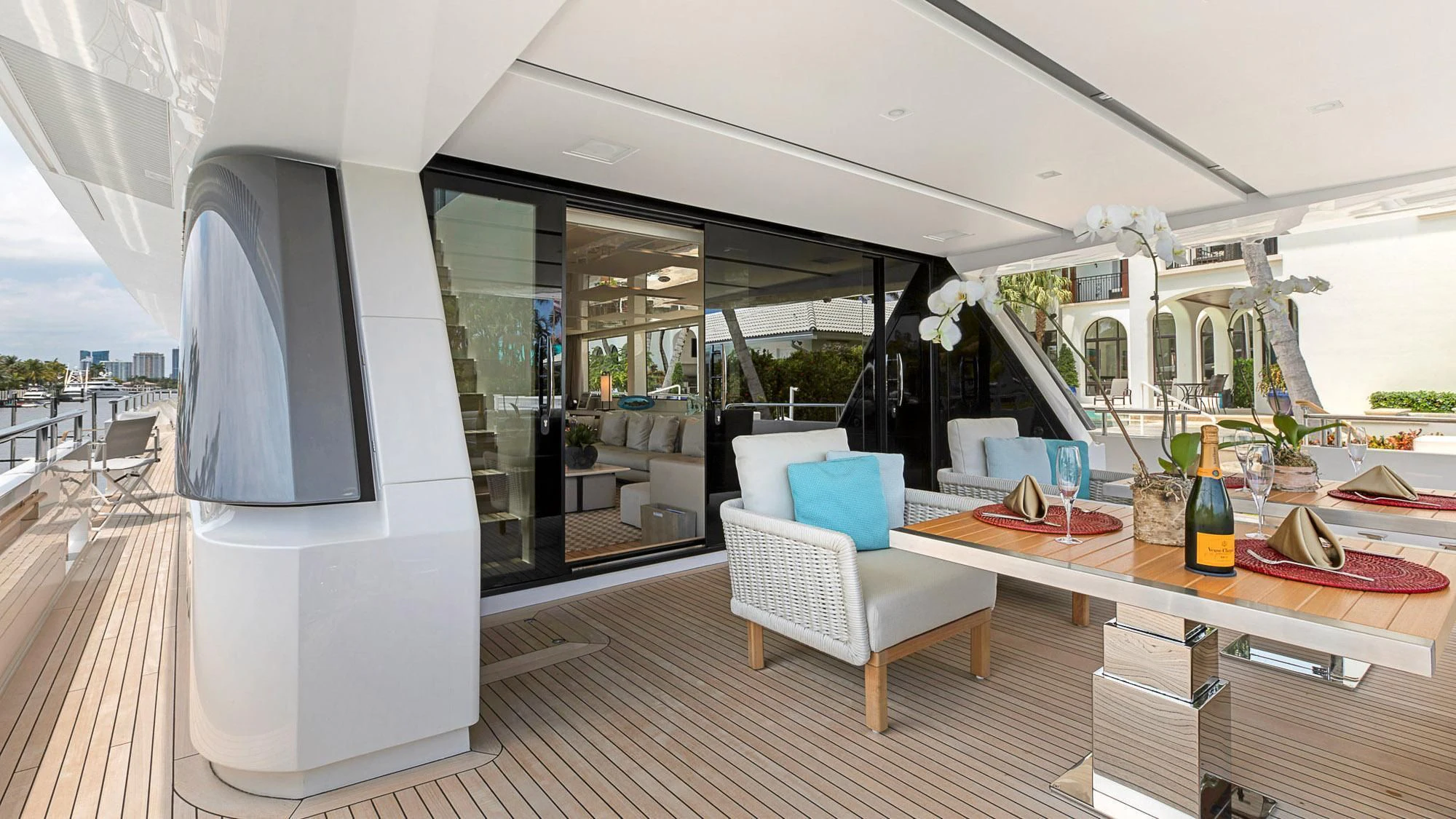 a glass walled patio with a table and chairs and a large glass window aboard CLEAR EYES Yacht for Sale