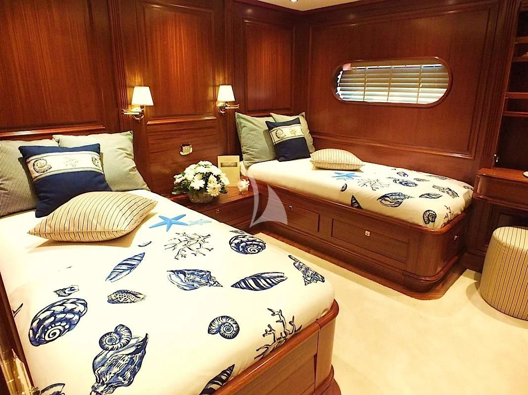 a bedroom with a bed and a dresser aboard CLEAR EYES Yacht for Sale