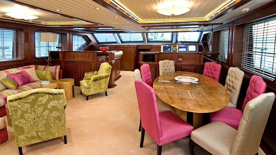 a room with a table chairs and a couch aboard CLEAR EYES Yacht for Sale